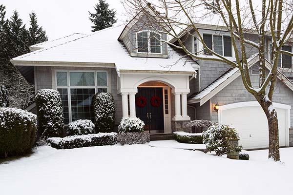 Front view of a home covered in snow